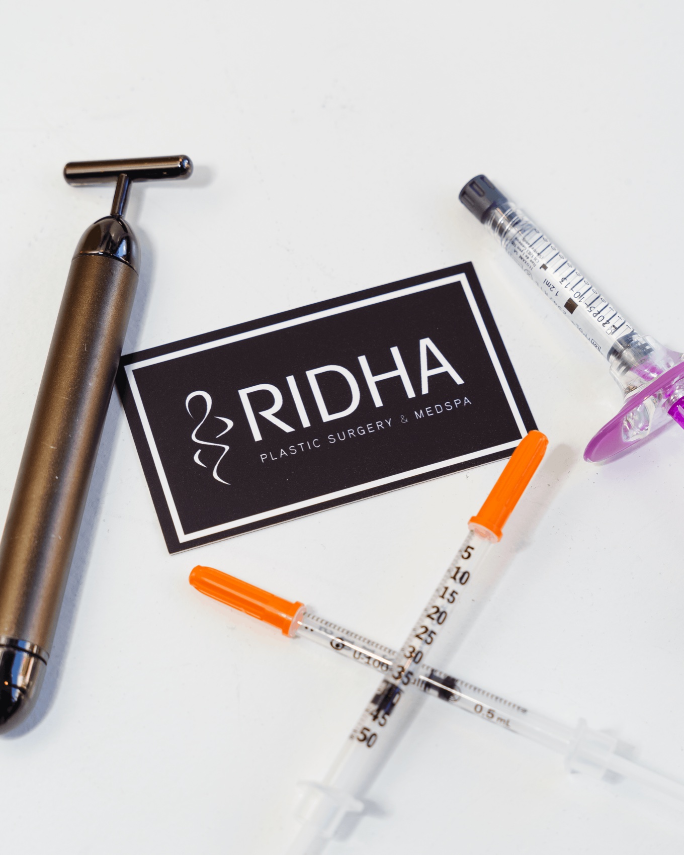 RIDHA branded card with med-spa treatment tools